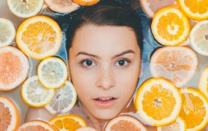 a woman in water with slices of oranges