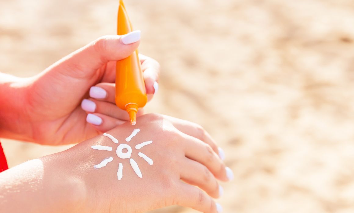 Woman putting sunscreen on hand